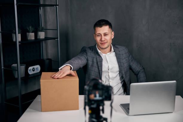 istock Handsome young man recording video and using laptop 1313489161
