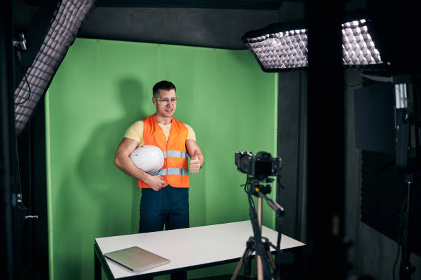 istock Cheerful male builder recording video for construction blog 1313489220