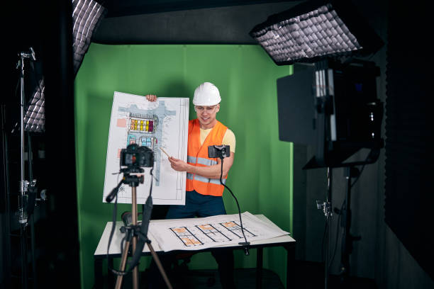 istock Cheerful male builder recording video for construction blog 1313489225