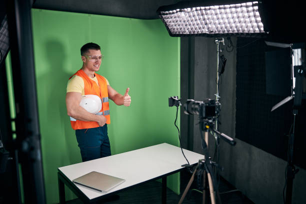 istock Joyful builder recording video with smartphone and giving thumbs up 1313489227