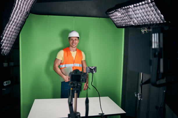 istock Cheerful male builder recording video with smartphone 1313489229