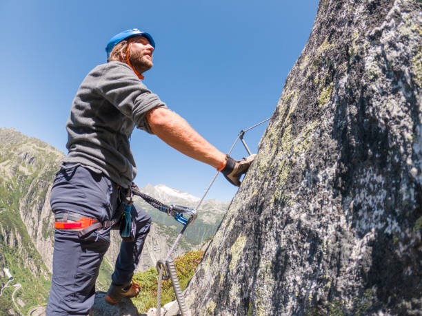 istock Man on Via Ferrata climbing up 1313489631