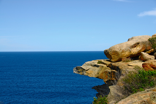 A rock outcrop over the eastern Pacific Ocean coastline near Watsons Bay, Australia.