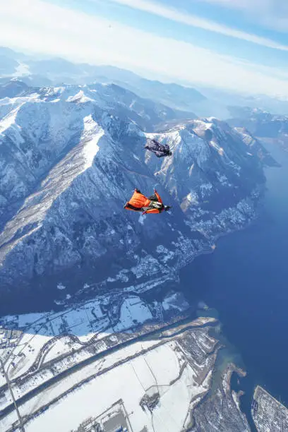 Photo of Wingsuit fliers soar above Swiss mountain landscape