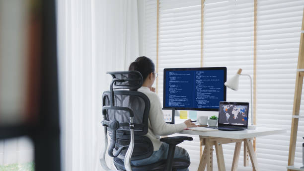 istock Back rear view of young asian woman, freelance data scientist work remotely at home coding programing on Big data mining, AI data engineering, IT Technician Works on Artificial Intelligence Project. 1313496064