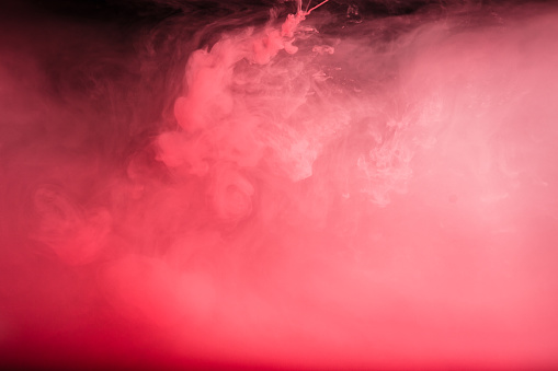 Pink ink cloud underwater. Abstract background.