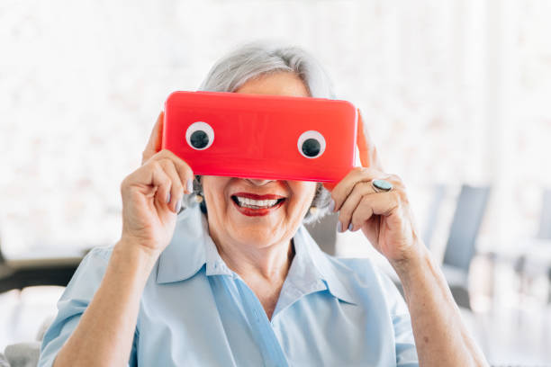istock Senior woman making faces with a funny mask 1313498647