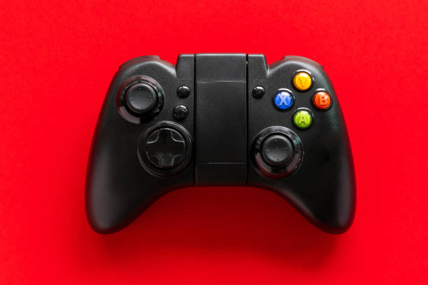 istock A Black game Joystick isolated on a red background 1313500741