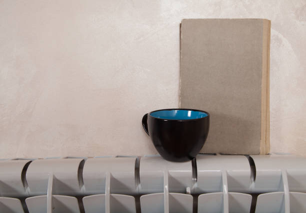 istock Electric whiter  heater with book and tea. 1313500949