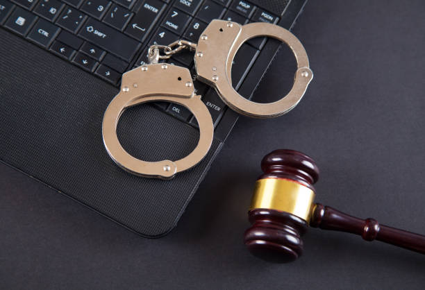 istock Judge gavel, police handcuffs and computer keyboard. 1313501030