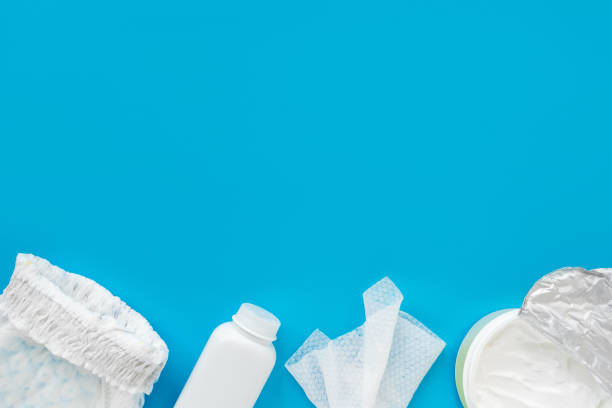 istock White powder, diaper, cream, napkin on a blue background, flatley, top view, copy space, mock up. Baby hygiene, background for newborn boys 1313503131
