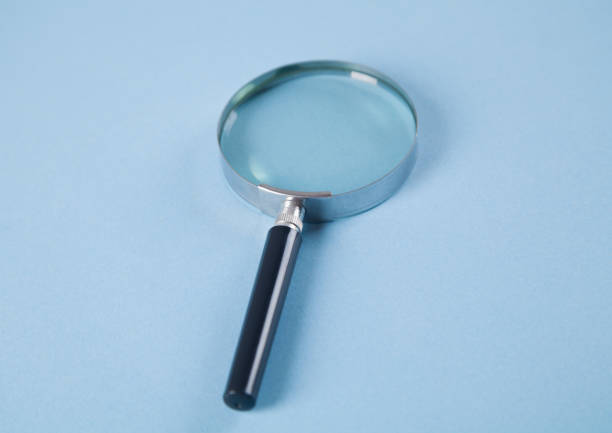 istock Magnifier on an isolated blue background. 1313503169