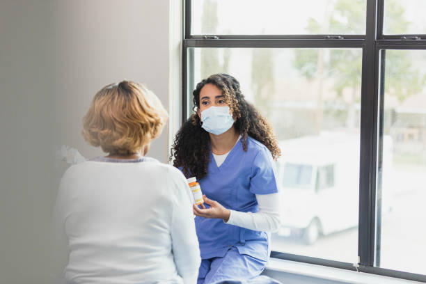 istock Serious nurse discusses medication with patient 1313504634
