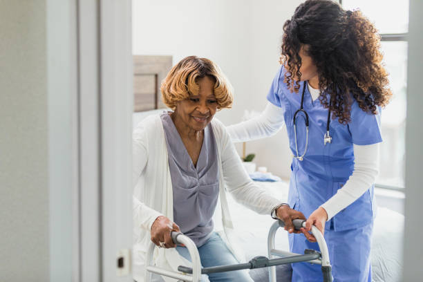 istock Confident senior woman prepares to stand with a nurse's help 1313504636