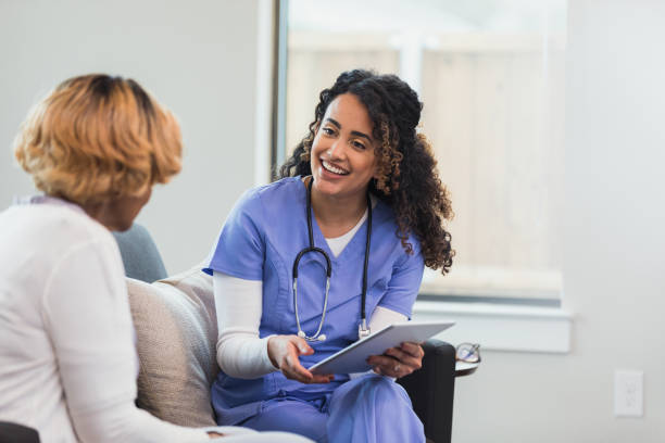 istock Mid adult nurse enters patient data on digital tablet 1313504843