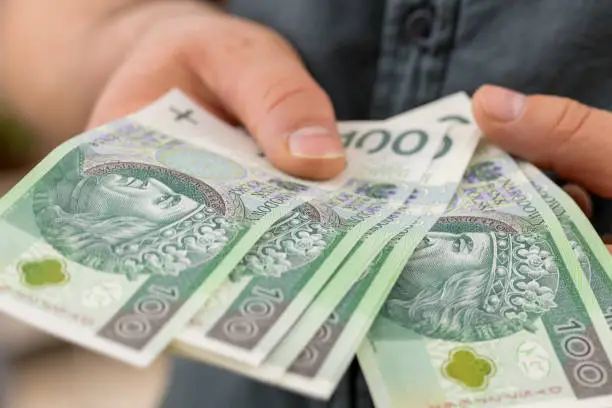 Polish money, Hundred zloty banknotes held in hands