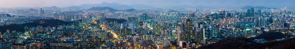 Aerial panorama over the illuminated sunset cityscape of central Seoul, South Korea’s vibrant capital city.