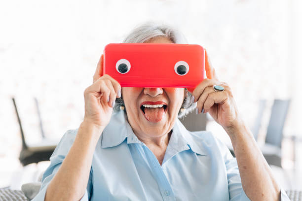 Senior woman making faces with a funny mask