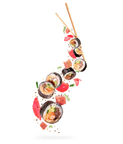 istock Fresh sushi rolls with various ingredients in the air on white background 1313515880