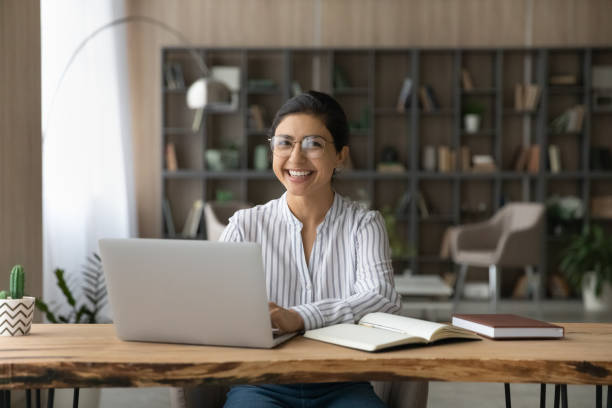 istock Portrait of happy Indian female study on computer online 1313516029