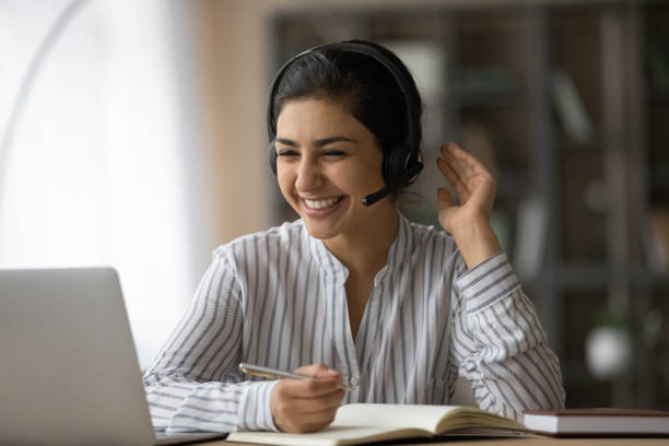 istock Smiling Indian female have online lesson on laptop 1313516043