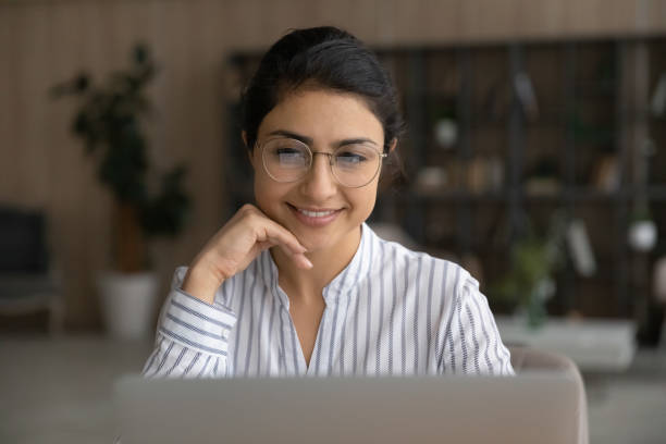 istock Smiling Indian woman work on laptop online 1313516051