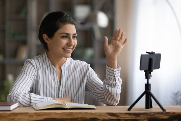 istock Smiling Indian woman coach talk on video call 1313516086