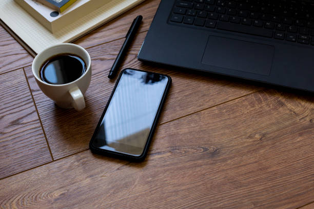 istock Standing on wooden floor, next to computer, phone and notebook-pen 1313517099
