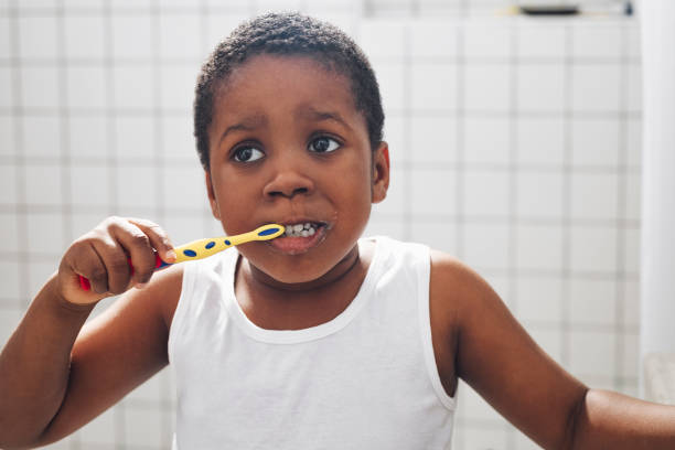 istock Young Boy Brushing His Teeth in The Bathroom 1313518696