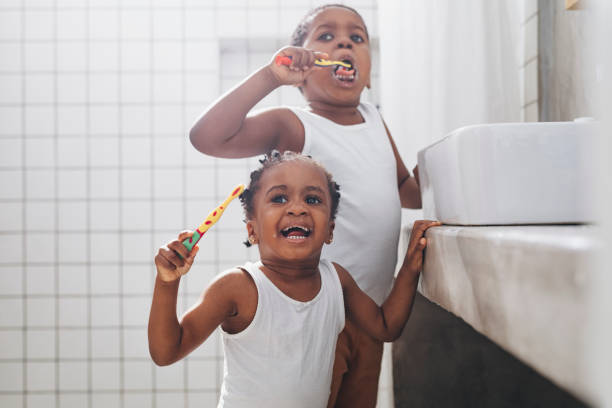 istock Young Girl and a Boy Brushing Their Teeth in a Bathroom 1313518700