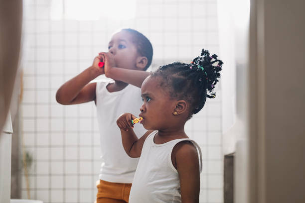 istock Young Girl and a Boy Brushing Their Teeth in a Bathroom 1313518706
