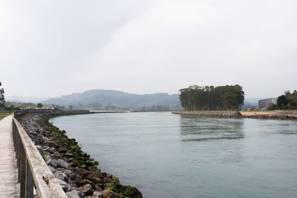 istock Beautiful walking path next to the river at Rodiles, Asturias. 1313520135