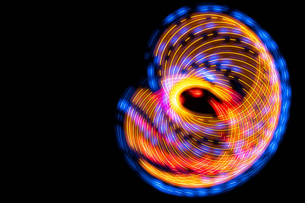 istock Abstract: Colorful Swirls of Light Creating Butterfly Pattern on a Black Background 1313522483