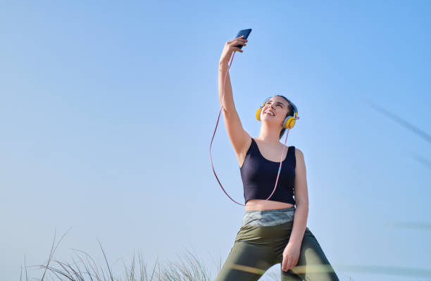 istock young woman dressed for sports taking a selfie 1313523664