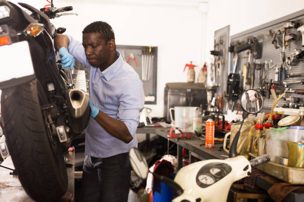 istock Worker repairing failed scooter in motorcycle garage 1313523840