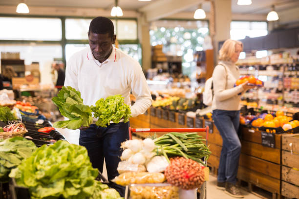 istock Man looking for vegetables in grocery store 1313524937