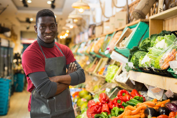 istock Smiling confident greengrocery owner 1313524943