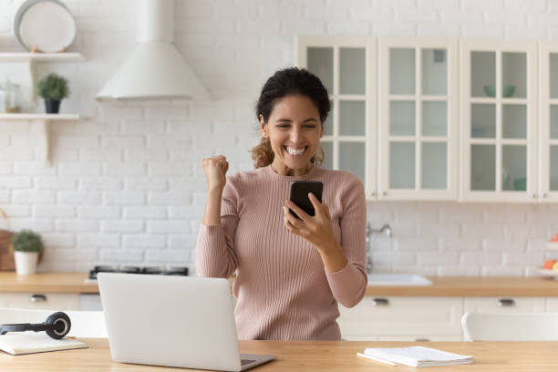 istock Overjoyed hispanic woman student receive message with good exam results 1313525185