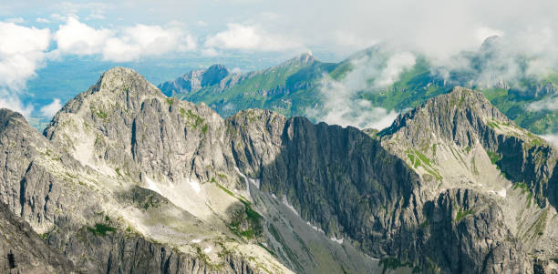 istock Panoramic view of Tatra mountain peaks and rocks covered with clouds 1313525338