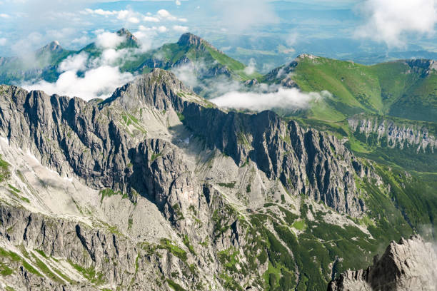 istock Panoramic view of Tatra mountain peaks and rocks covered with clouds 1313525518
