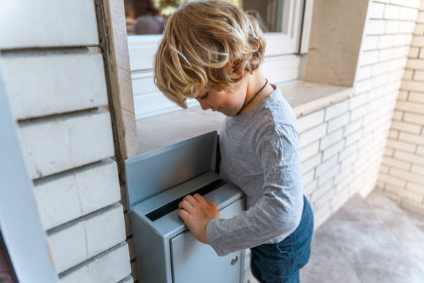 istock Cute Caucasian Boy Checking Mailbox At Home 1313527688