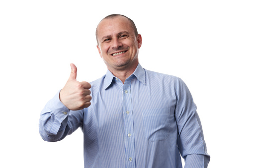 Successful caucasian businessman in blue shirt with stripes showing thumbs up sign, isolated on white background