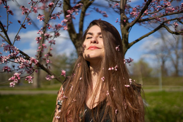 istock Young woman with cherry trees in bloom 1313529207