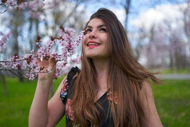 istock Young woman with cherry trees in bloom 1313529215