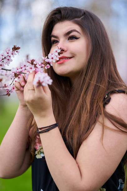 istock Young woman with cherry trees in bloom 1313529232