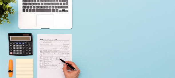 Tax income concept with US tax form Tax income concept with US tax form. Documents on desk, top view tax stock pictures, royalty-free photos & images
