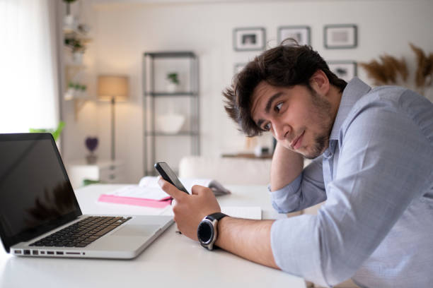 istock Young man using social media at home 1313532720