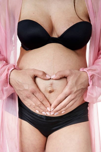 istock Pregnant woman posing isolated on white 1313534239