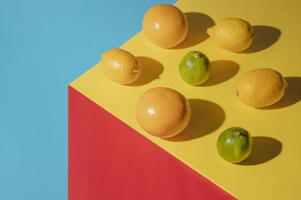 istock Healty aranger fresh fruit on colorful background. Minimal summer concept. 1313535176