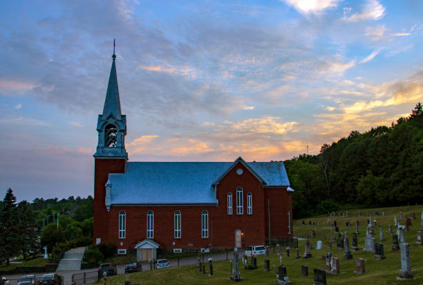 istock Sunset over a small town church in Quebec, Canada 1313540682